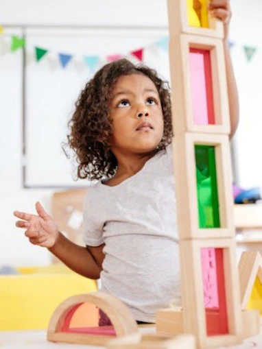 Girl stacking blocks on a table