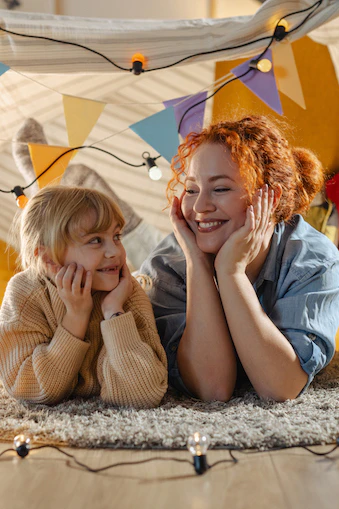 Nanny and Child having fun in an indoor fort
