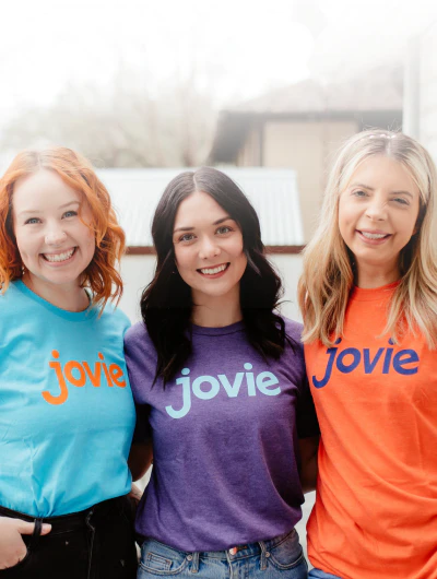 Women with Jovie shirts smiling at the camera