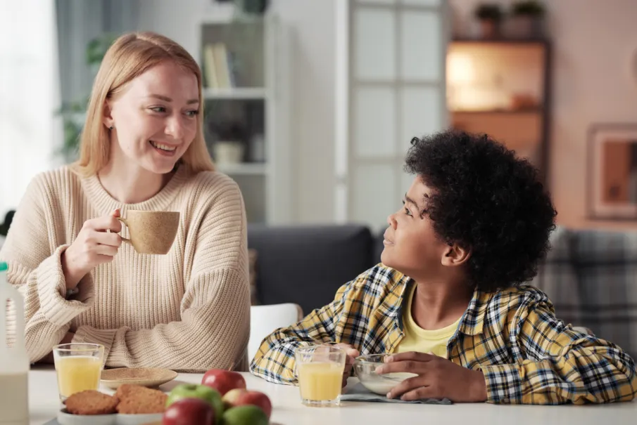Parent and child enjoying breakfast together at home