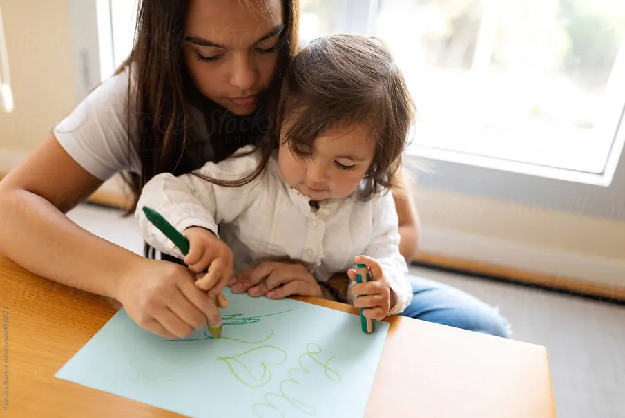 Mother and child drawing together at home